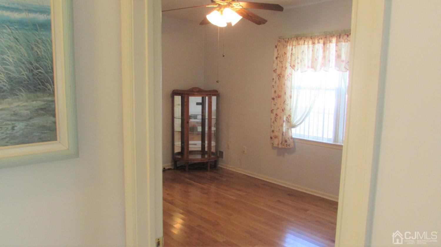 91 Wordsworth Road Brick, NJ 08724 - Photo 10 of 41 a view of an empty room with window and wooden floor