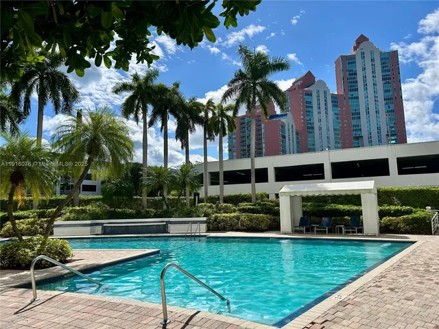 a swimming pool with outdoor seating and yard