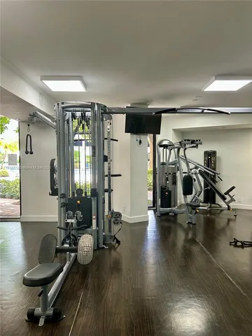 a room with gym equipment and a large window