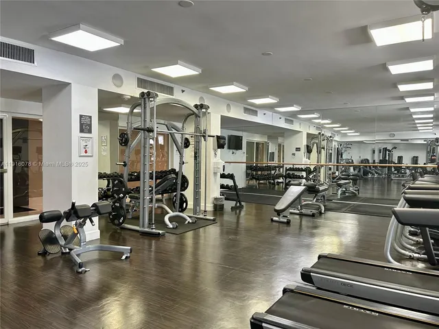 a gym room with lots of gym equipment