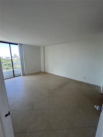 an empty room with large windows