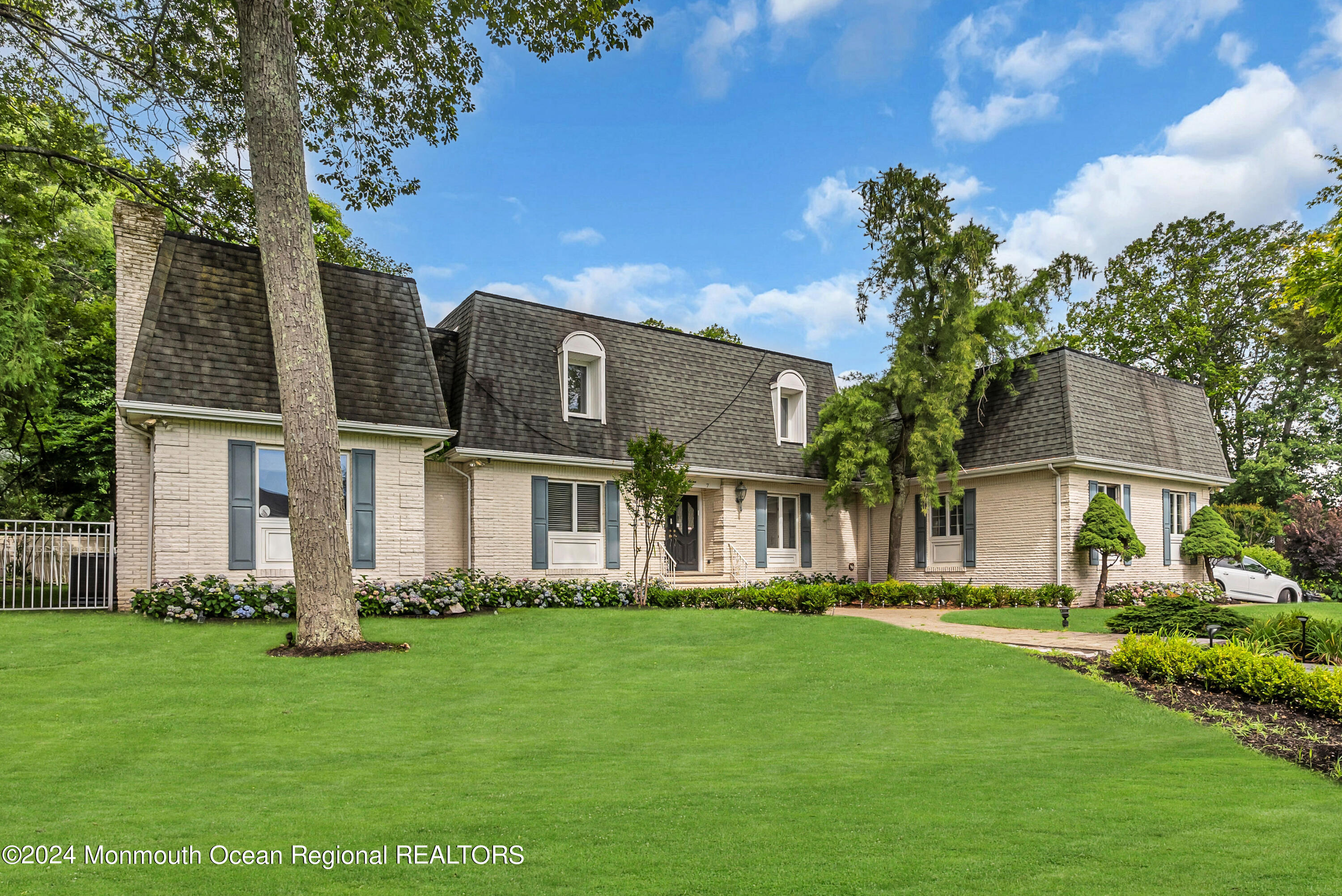 7 Decamp Court West Long Branch, NJ 07764 - Photo 1 of 32 a front view of a house with a garden