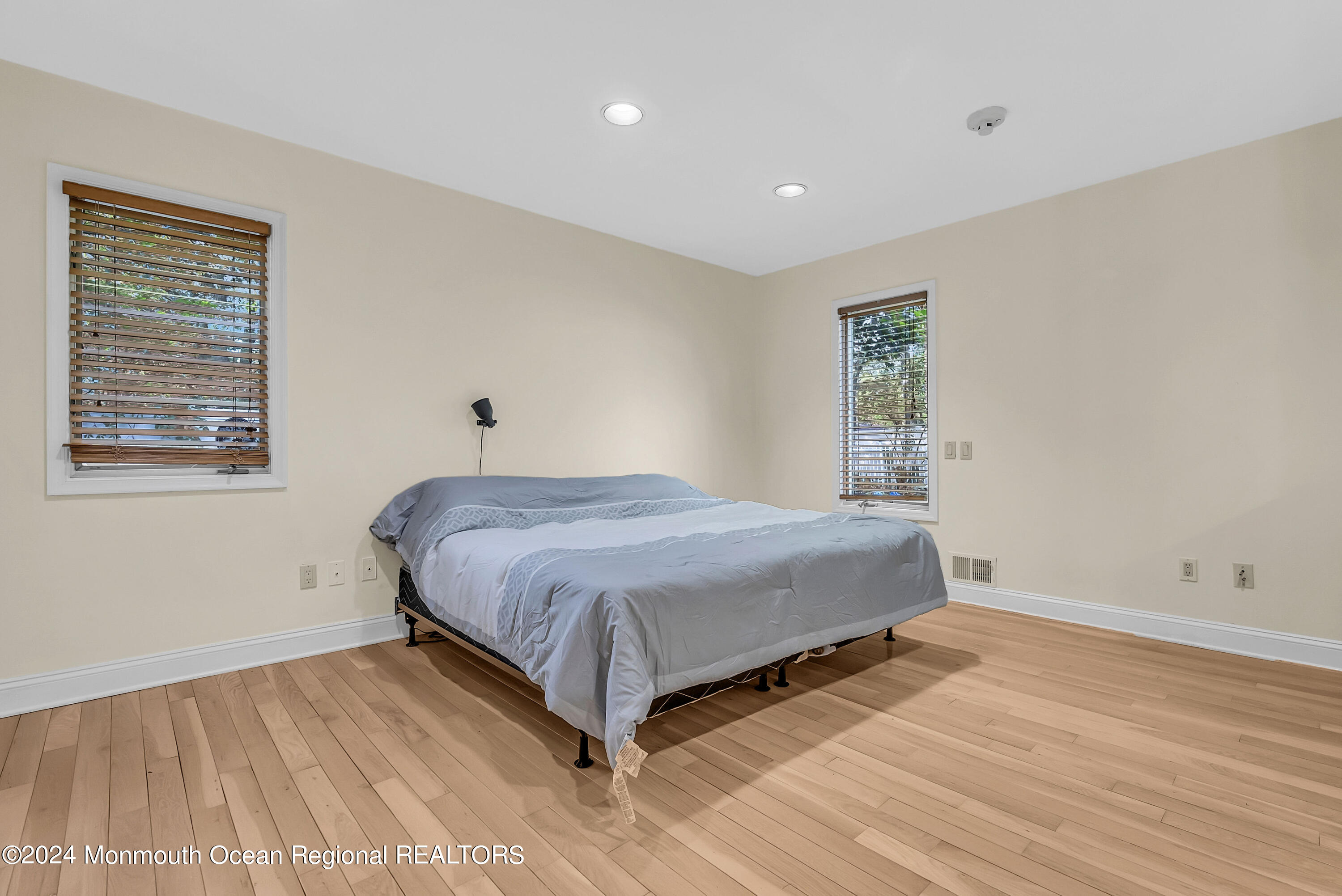 7 Decamp Court West Long Branch, NJ 07764 - Photo 14 of 32 a spacious bedroom with a bed and a window