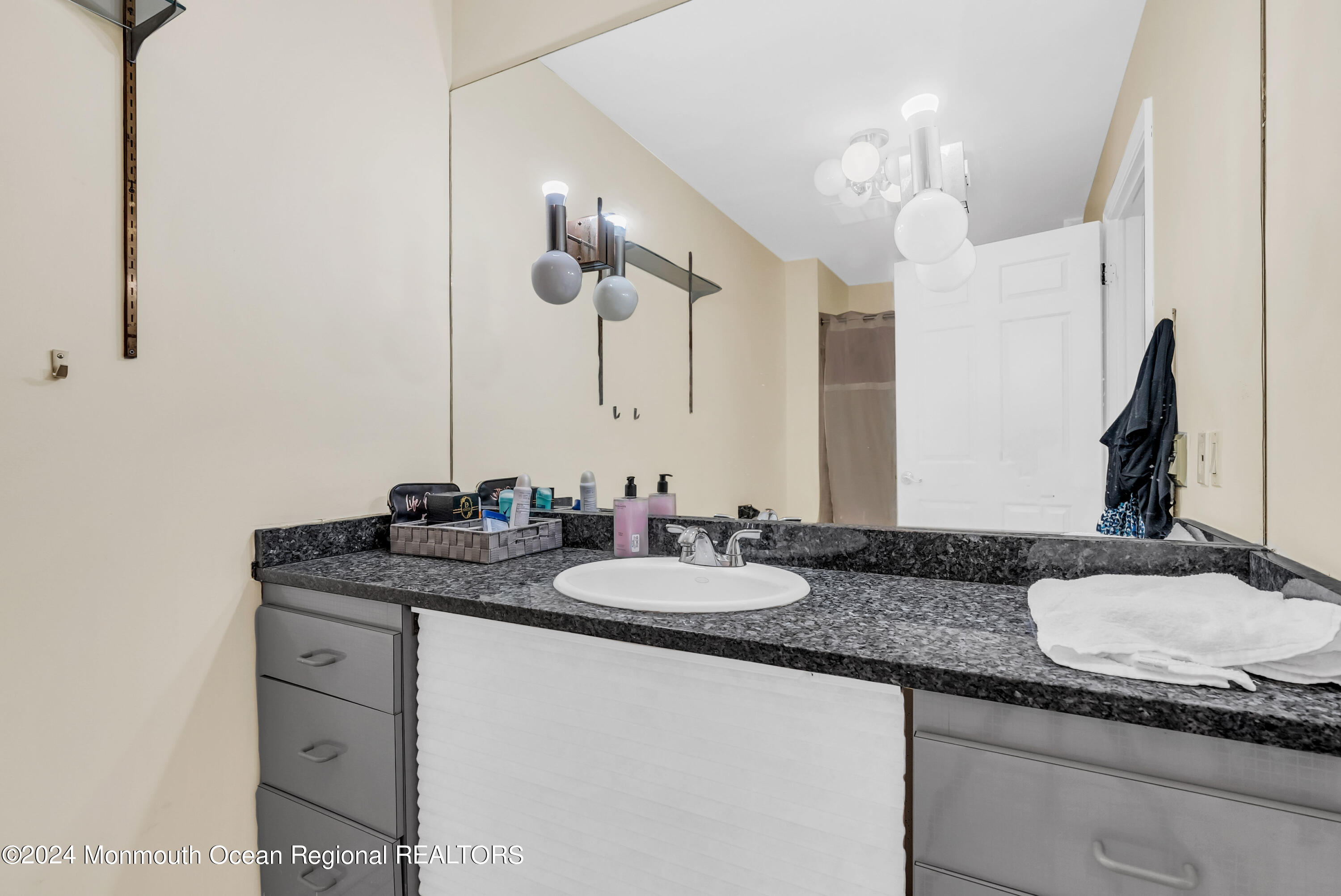 7 Decamp Court West Long Branch, NJ 07764 - Photo 15 of 32 a bathroom with a granite countertop sink and a mirror