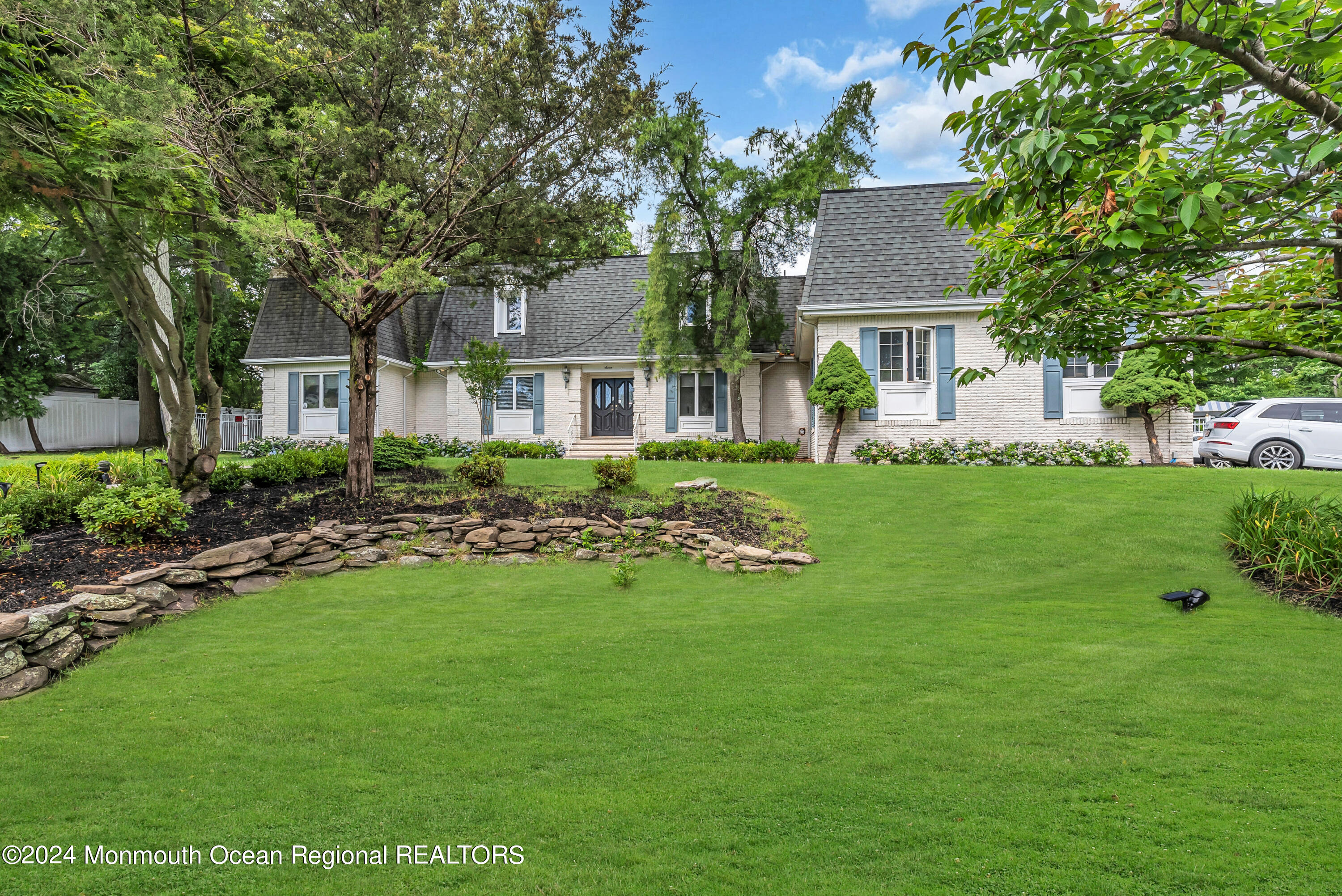 7 Decamp Court West Long Branch, NJ 07764 - Photo 2 of 32 a front view of a house with a garden