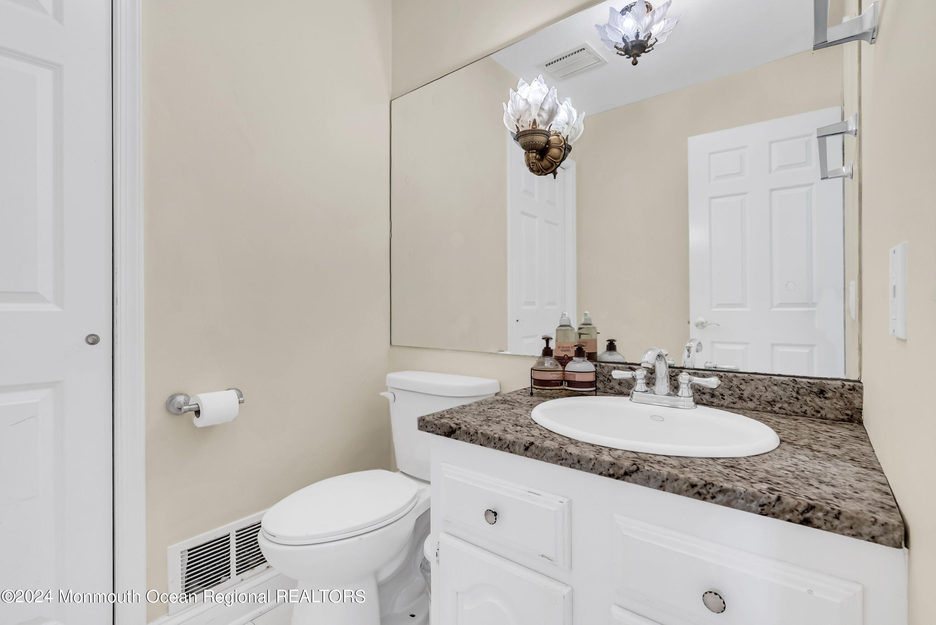7 Decamp Court West Long Branch, NJ 07764 - Photo 21 of 32 a bathroom with a granite countertop sink a toilet and a mirror
