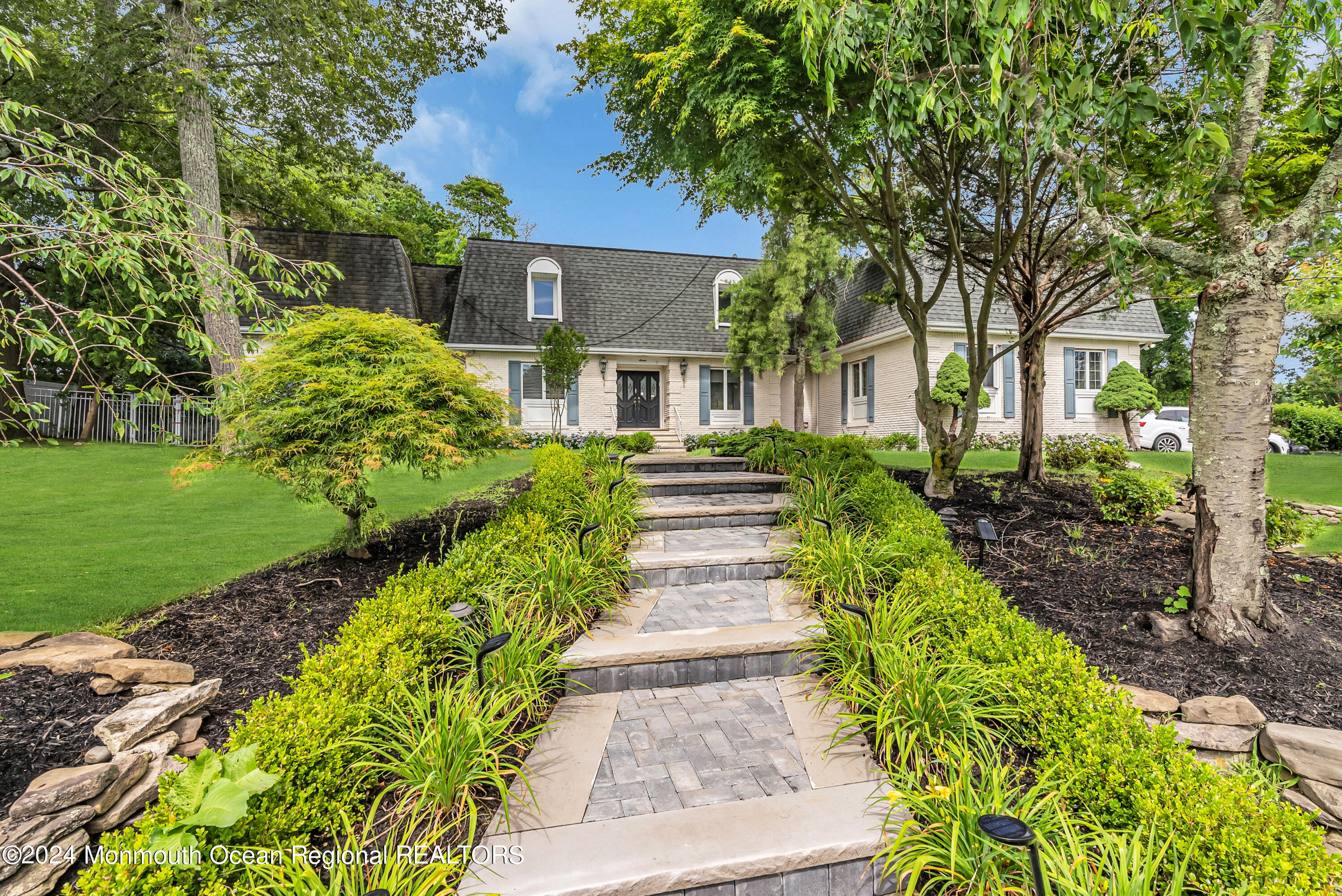 7 Decamp Court West Long Branch, NJ 07764 - Photo 3 of 32 a front view of a house with a garden
