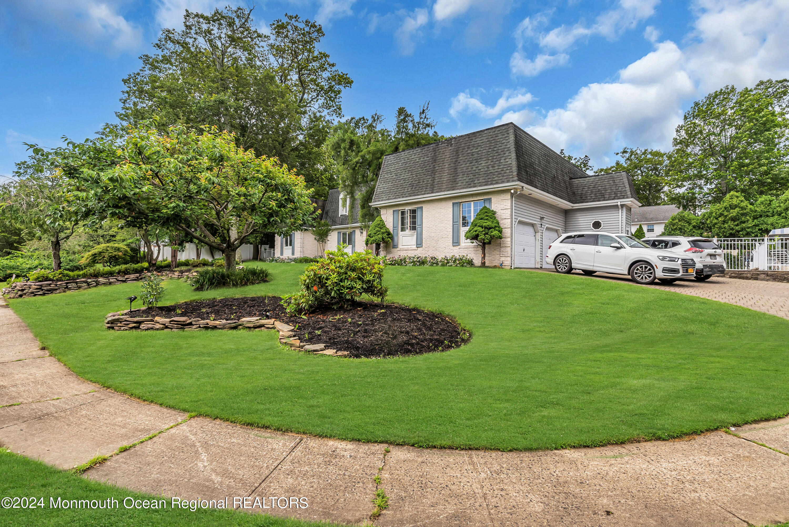 7 Decamp Court West Long Branch, NJ 07764 - Photo 4 of 32 a view of a big house with a big yard plants and large trees