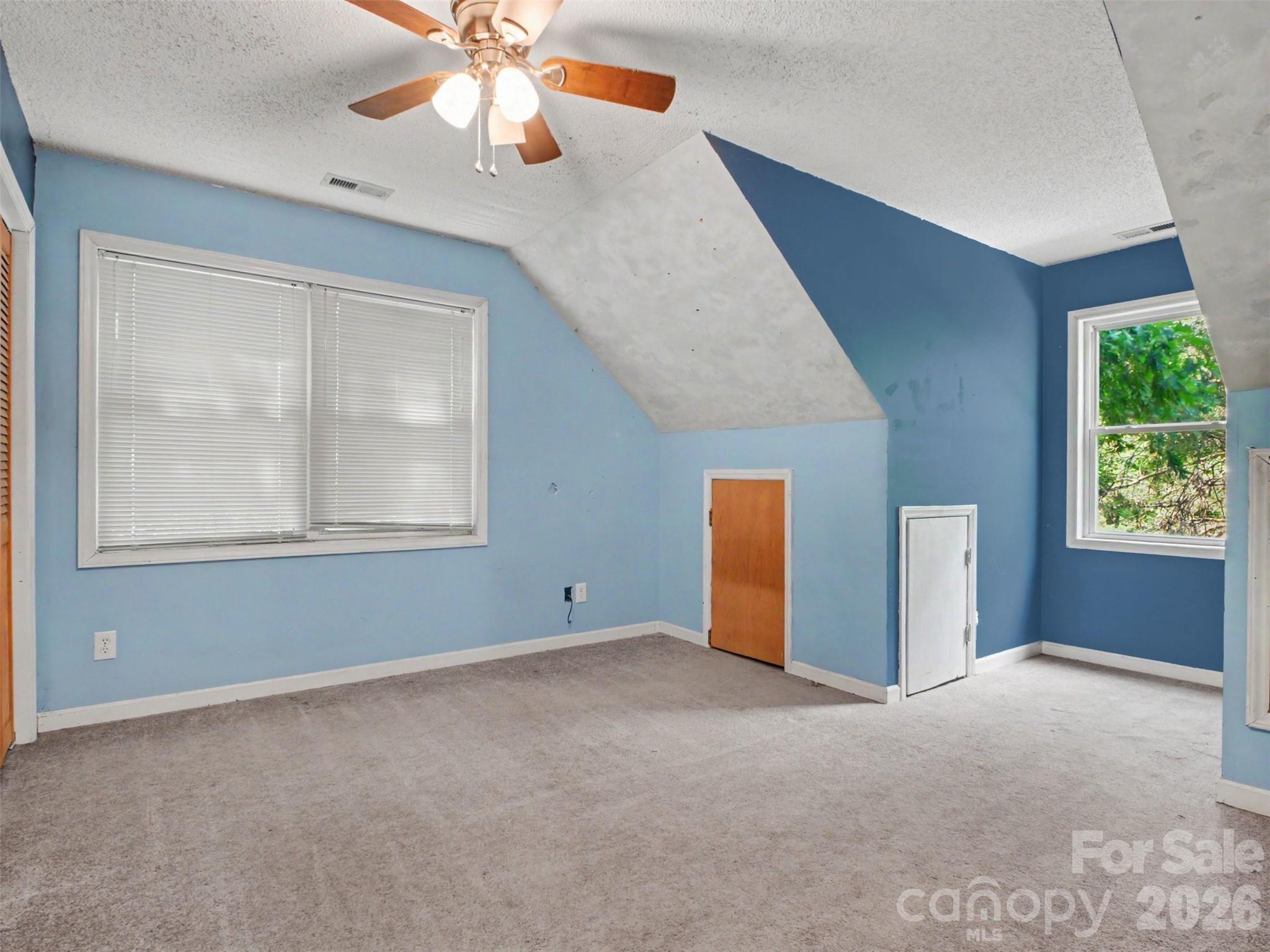 11109 Asbury Chapel Road Huntersville, NC 28078 - Photo 15 of 33 an empty room with windows and fan
