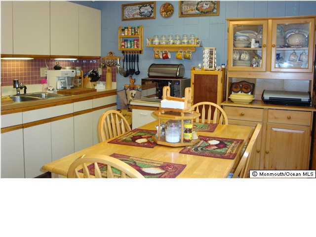 26 Annapolis Road Toms River, NJ 08757 - Photo 3 of 3 a kitchen with stainless steel appliances kitchen island granite countertop a sink and cabinets