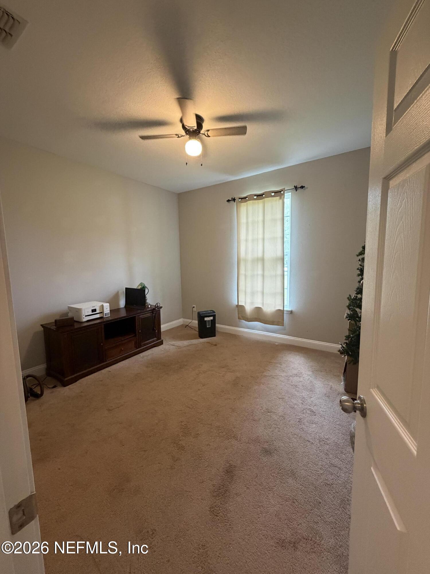 204 Comer Road Palatka, FL 32177 - Photo 7 of 15 a room with window and a ceiling fan