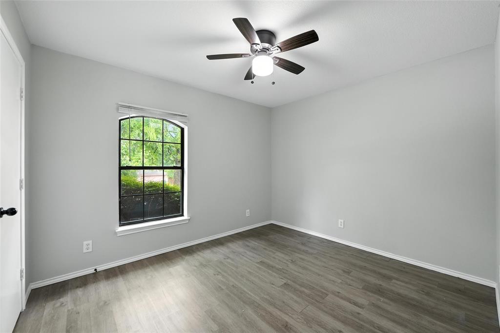 602 Valleyridge Court Decatur, TX 76234 - Photo 15 of 27 an empty room with wooden floor and windows