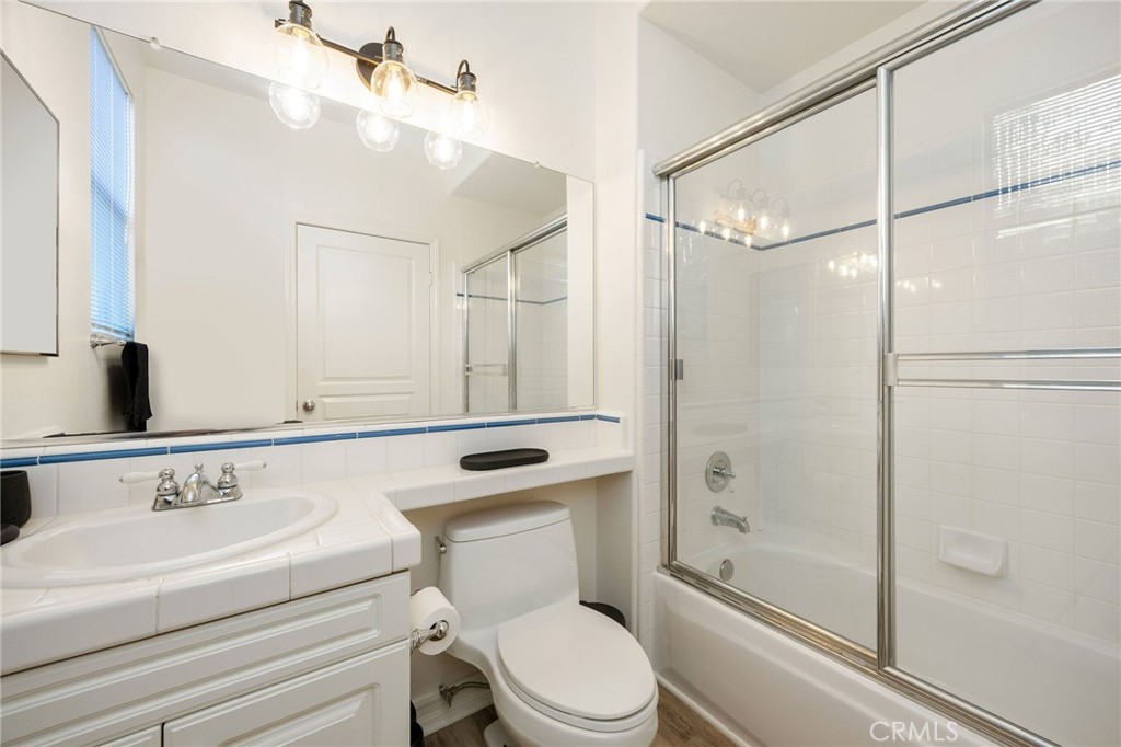 7211 Rock Ridge Terrace West Hills, CA 91307 - Photo 17 of 38 a bathroom with a sink a mirror a toilet and shower