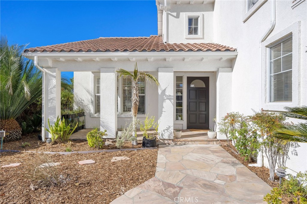 7211 Rock Ridge Terrace West Hills, CA 91307 - Photo 2 of 38 a view of a house with potted plants and a large window