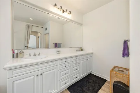 a bathroom with a double vanity sink a mirror and a