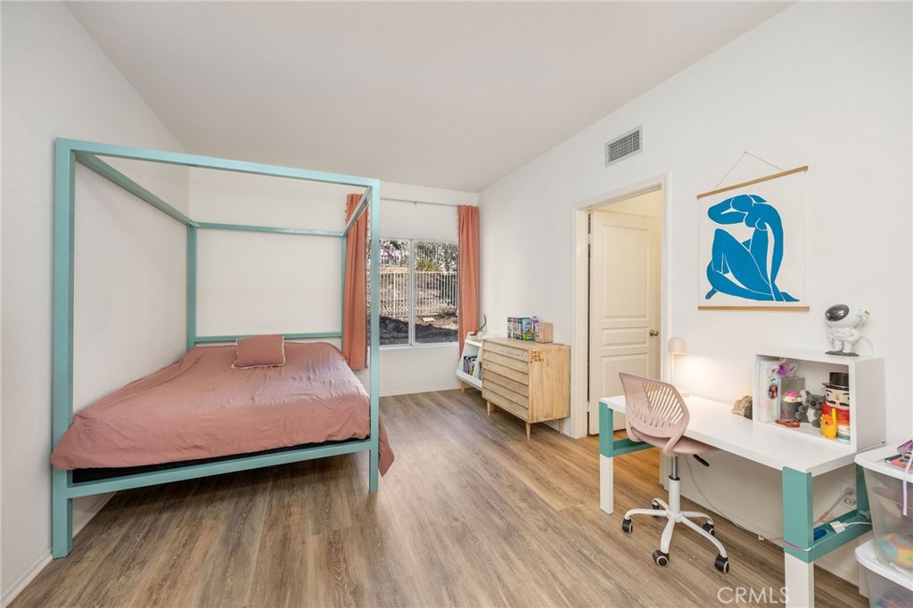 7211 Rock Ridge Terrace West Hills, CA 91307 - Photo 25 of 38 a bedroom with a bed and a wooden floor