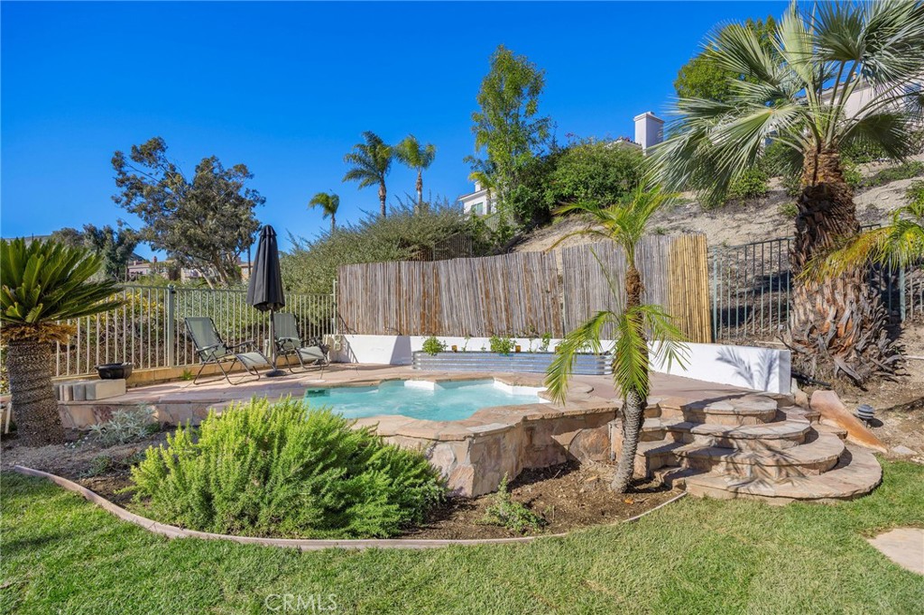7211 Rock Ridge Terrace West Hills, CA 91307 - Photo 37 of 38 a view of a backyard with plants and palm tree