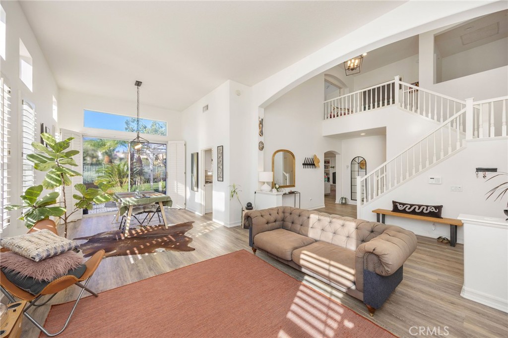 7211 Rock Ridge Terrace West Hills, CA 91307 - Photo 6 of 38 a living room with furniture and a chandelier