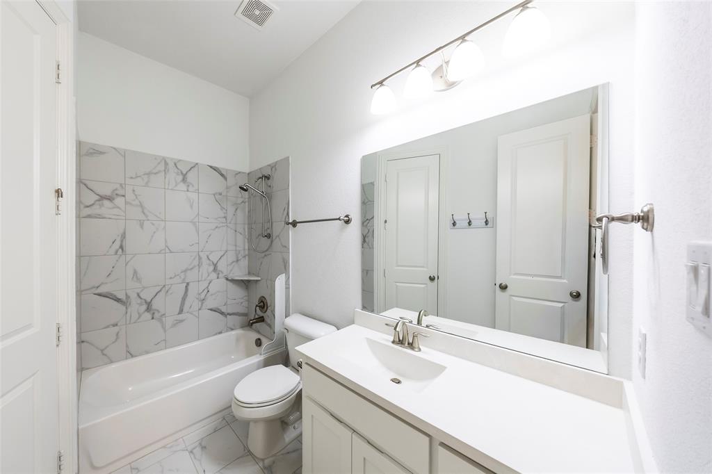 1650 Oakcrest Drive Prosper, TX 75078 - Photo 26 of 40 Bathroom featuring tub / shower combination, vanity, and marble look tile flooring