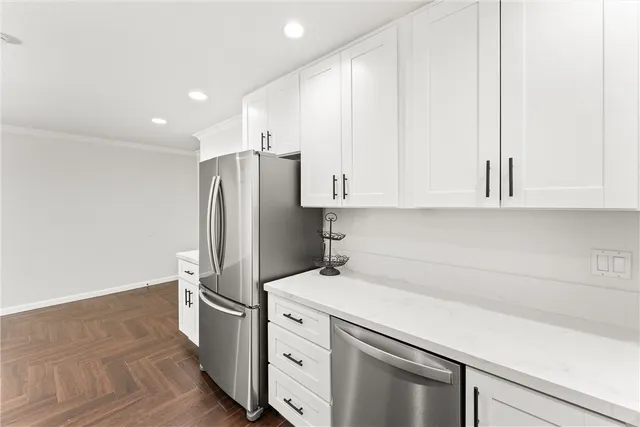 a kitchen with stainless steel appliances a refrigerator sink and cabinets