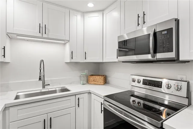 a kitchen with appliances cabinets and a sink