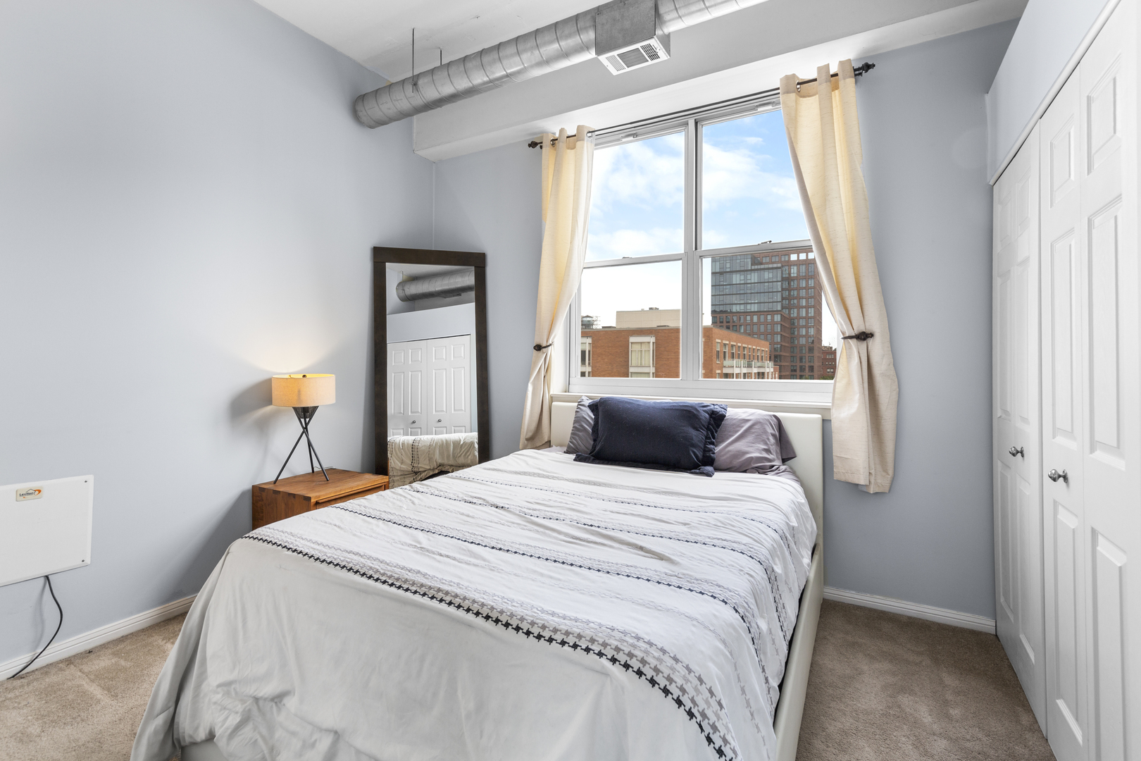 950 West Monroe Street, Unit 616 Chicago, IL 60607 - Photo 15 of 28 a bedroom with a bed and a window