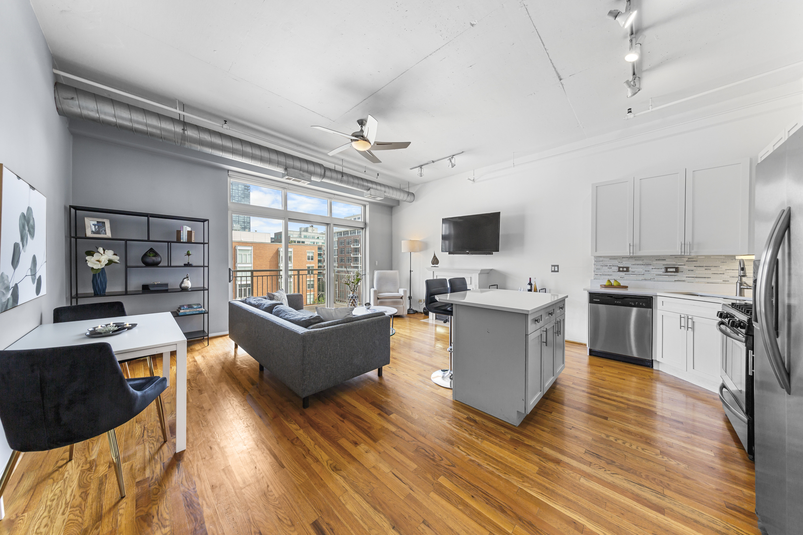 950 West Monroe Street, Unit 616 Chicago, IL 60607 - Photo 3 of 28 a large living room with stainless steel appliances granite countertop a couch and a view of living room