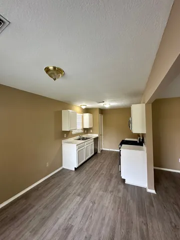 a kitchen with a refrigerator and a stove top oven