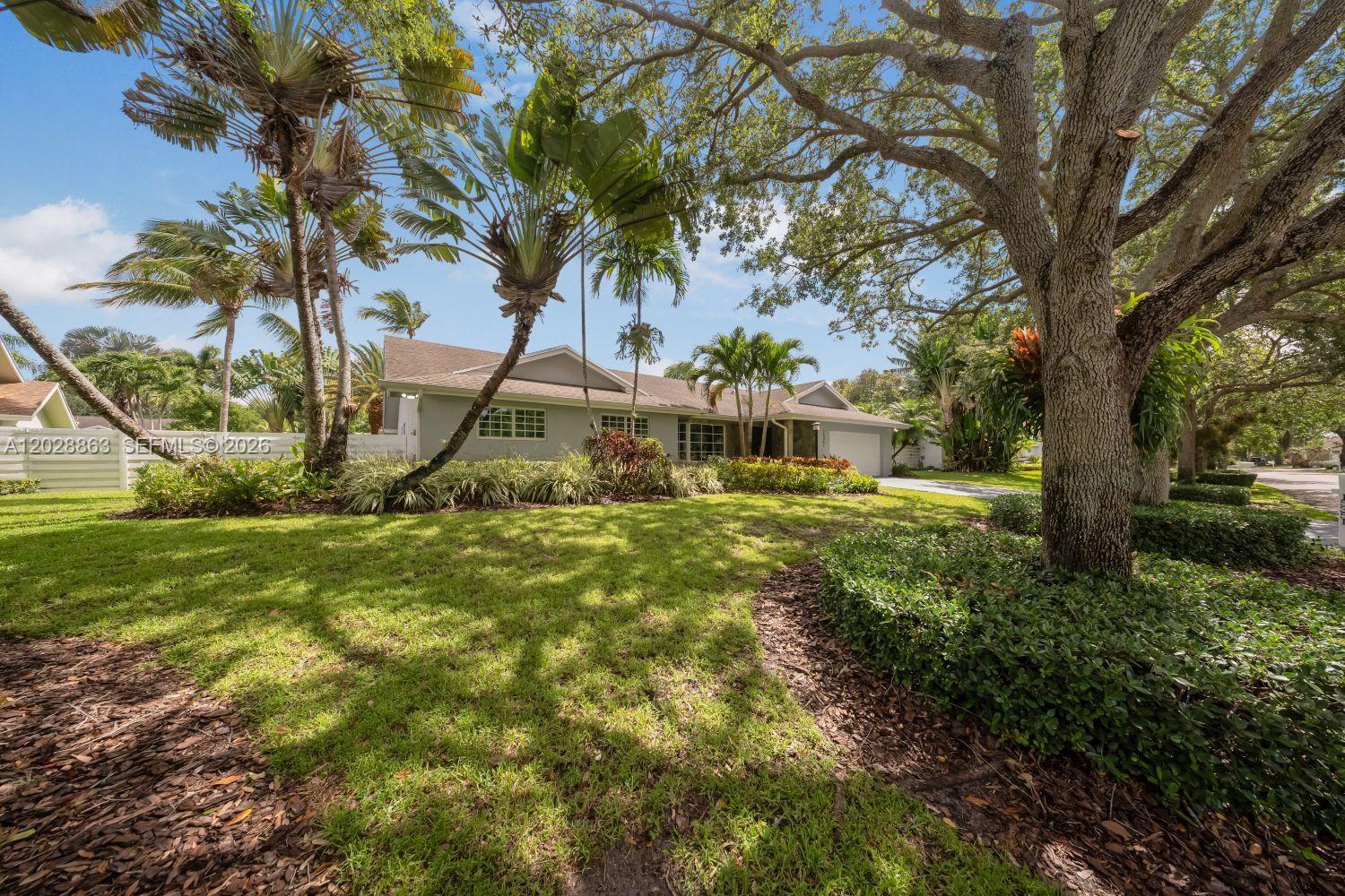 15351 Southwest 146th Street Miami, FL 33196 - Photo 2 of 86 Oak trees and Mature landscapes adorn the front of the property.