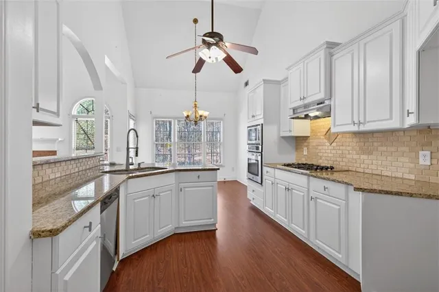 a kitchen with granite countertop cabinets and a stove