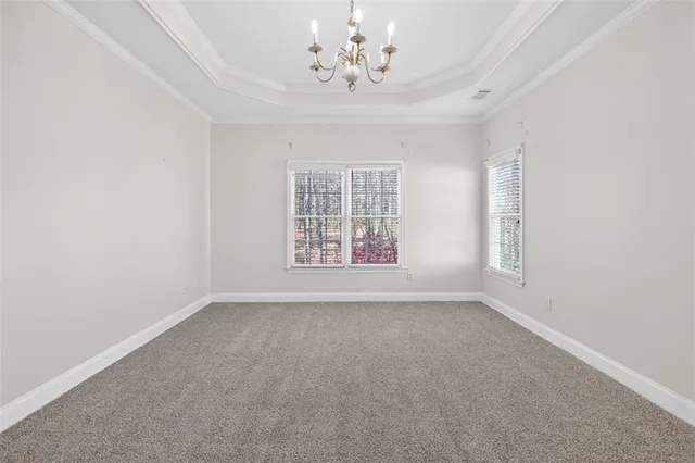 a view of an empty room with chandelier