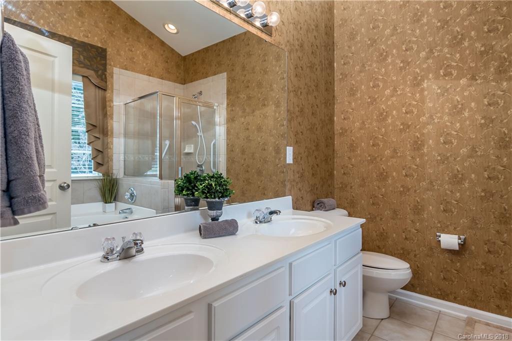 134 Whitley Mills Road, Unit 78 Fort Mill, SC 29708 - Photo 13 of 25 a bathroom with a sink a toilet and a mirror