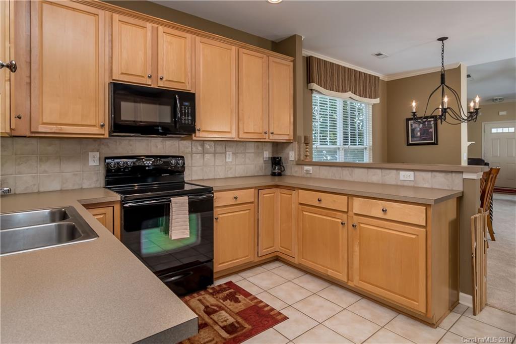 134 Whitley Mills Road, Unit 78 Fort Mill, SC 29708 - Photo 9 of 25 a kitchen with granite countertop a sink stainless steel appliances and cabinets