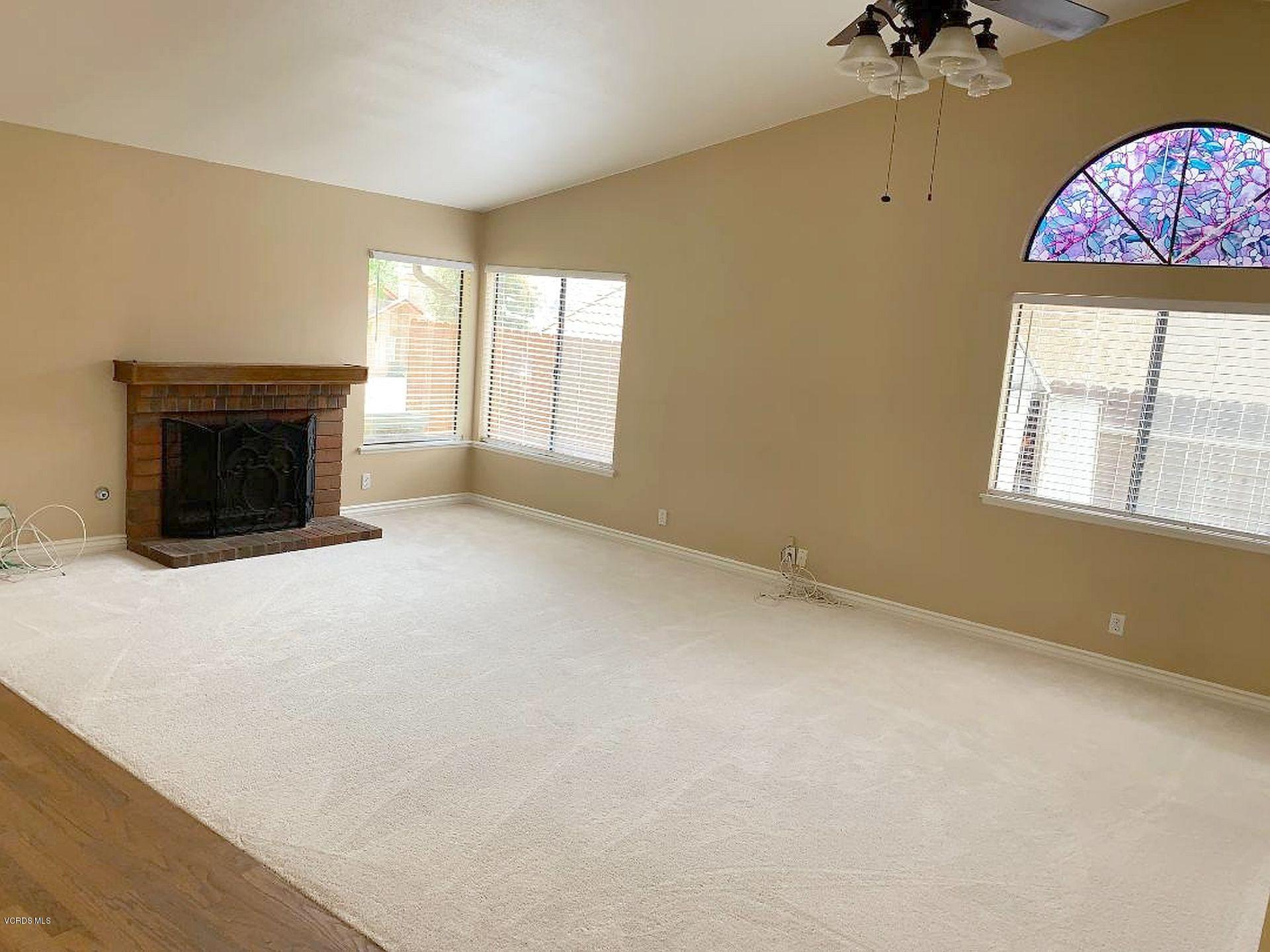 13653 Bear Valley Road Moorpark, CA 93021 - Photo 3 of 18 an empty room with windows and fireplace