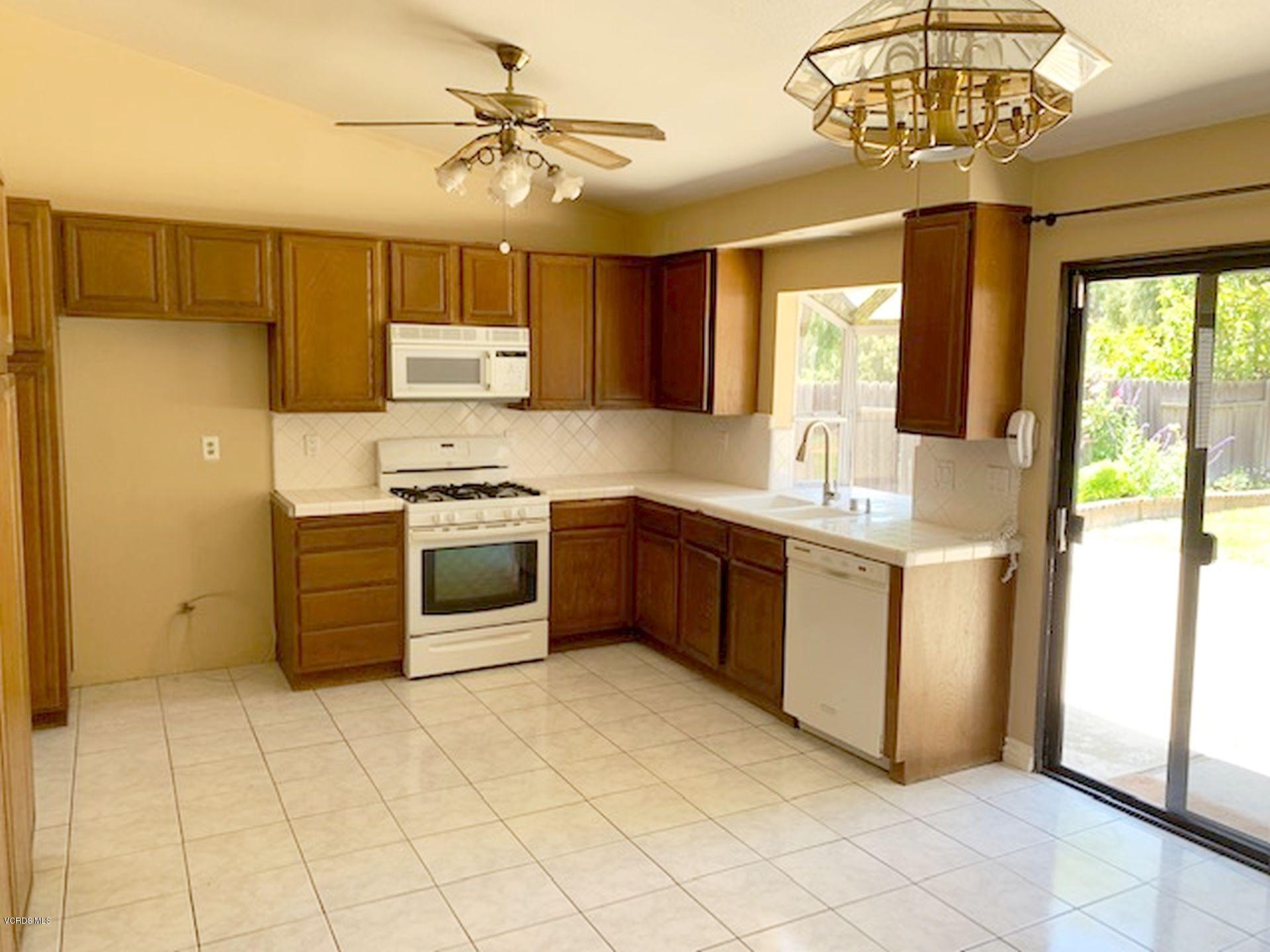 13653 Bear Valley Road Moorpark, CA 93021 - Photo 5 of 18 a kitchen with stainless steel appliances granite countertop a stove a sink and a refrigerator