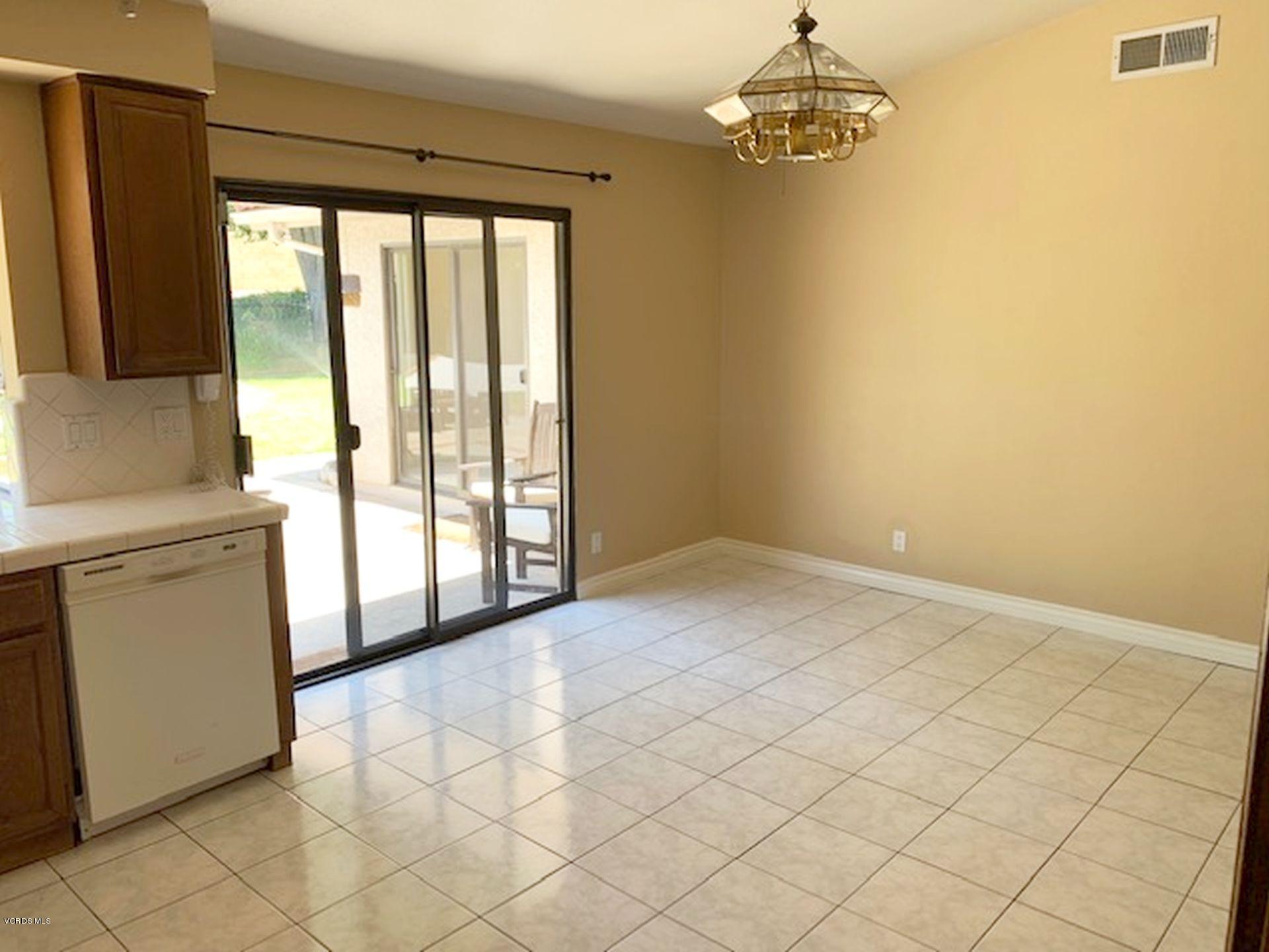 13653 Bear Valley Road Moorpark, CA 93021 - Photo 7 of 18 a view of a kitchen with a dishwasher cabinets and a floor to ceiling window