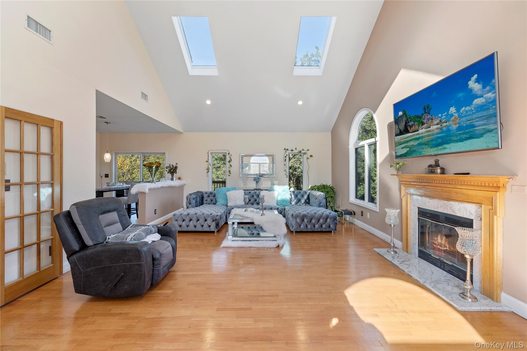 35 Pierce Road Stony Point, NY 10980 - Photo 12 of 45 Living area with a fireplace, a skylight, light wood-type flooring, healthy amount of natural light, and high vaulted ceiling