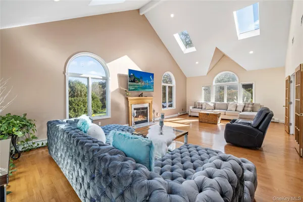 a living room with furniture fireplace and a large window