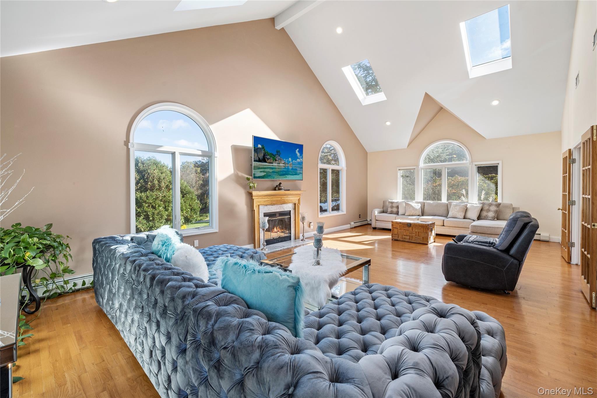 35 Pierce Road Stony Point, NY 10980 - Photo 13 of 45 Living area with a skylight, high vaulted ceiling, light wood-style flooring, a fireplace, and recessed lighting
