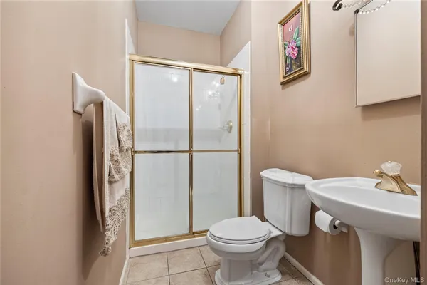 a white toilet sitting next to a bathroom sink