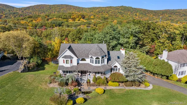 an aerial view of a house with a big yard and large trees