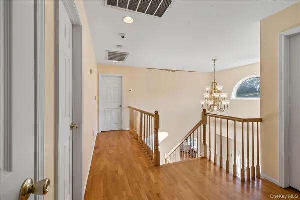 a kitchen with a dining table chairs stove and white cabinets