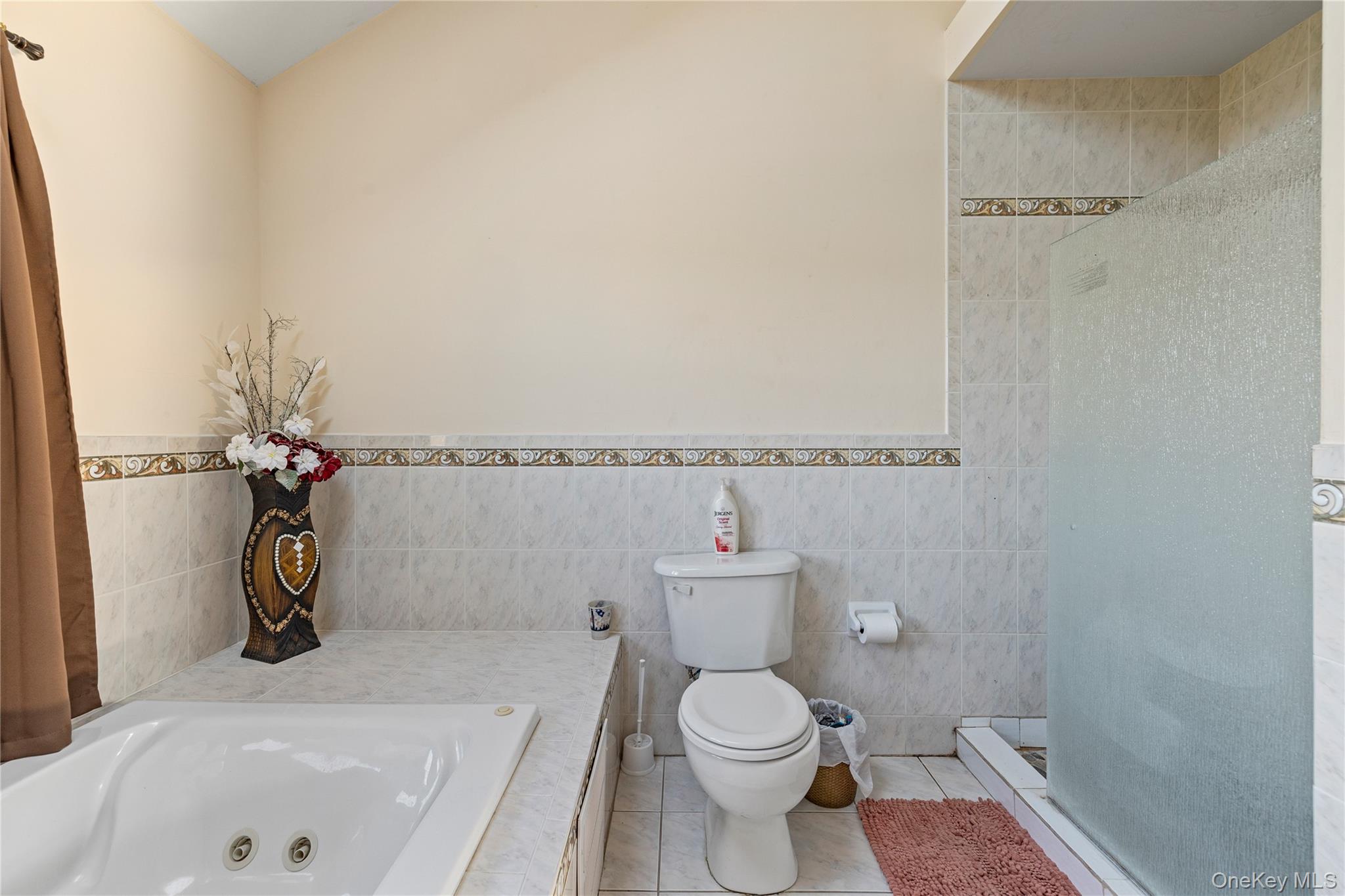 35 Pierce Road Stony Point, NY 10980 - Photo 26 of 45 Full bathroom with tile walls, light tile patterned floors, a wainscoted wall, a shower stall, and a whirlpool tub
