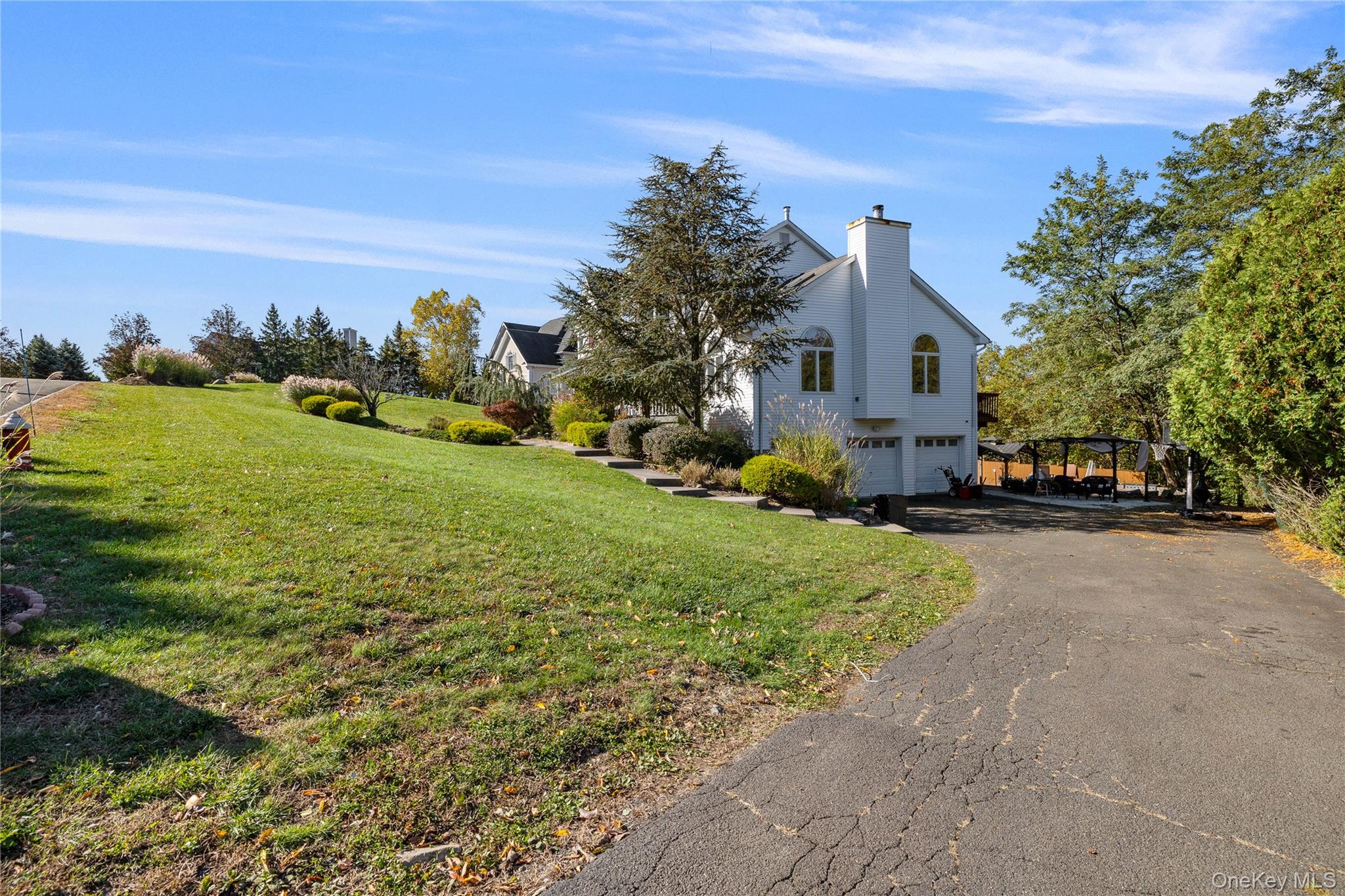 35 Pierce Road Stony Point, NY 10980 - Photo 36 of 45 View of side of home with asphalt driveway, a lawn, a chimney, and a garage