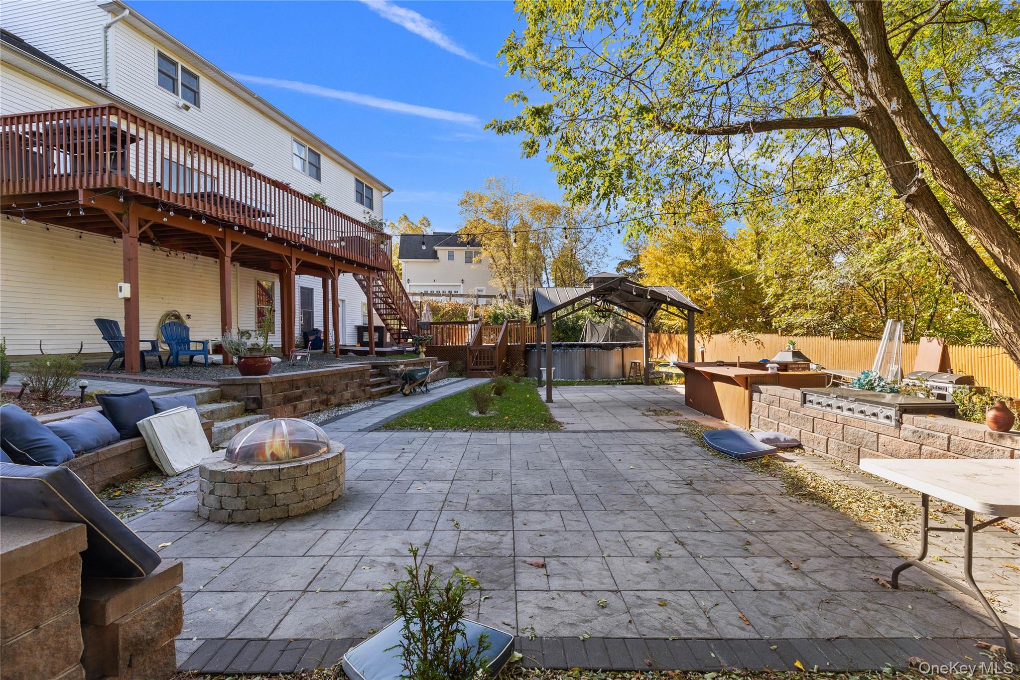 35 Pierce Road Stony Point, NY 10980 - Photo 37 of 45 Fenced backyard with a patio, a fire pit, an outdoor kitchen, a deck, and stairs
