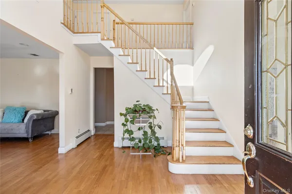 a view of entryway and hall with wooden floor