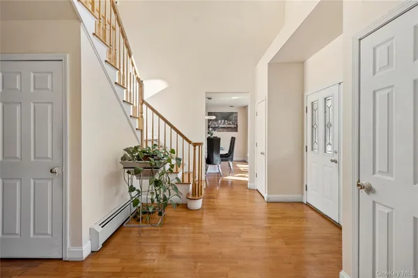 a view of entryway and hall with wooden floor