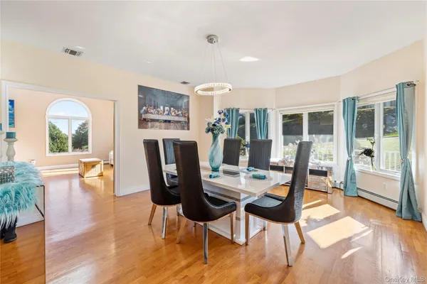 a view of a dining room with furniture window and wooden floor