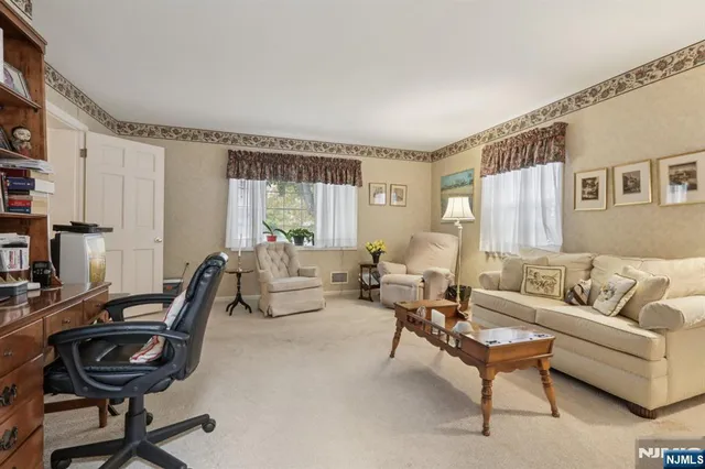 a view of a a dining room with furniture window and wooden floor