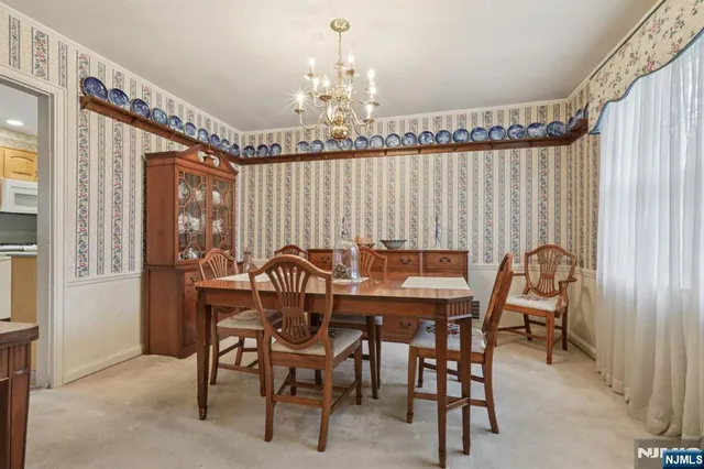 a view of a dining room with furniture and chandelier